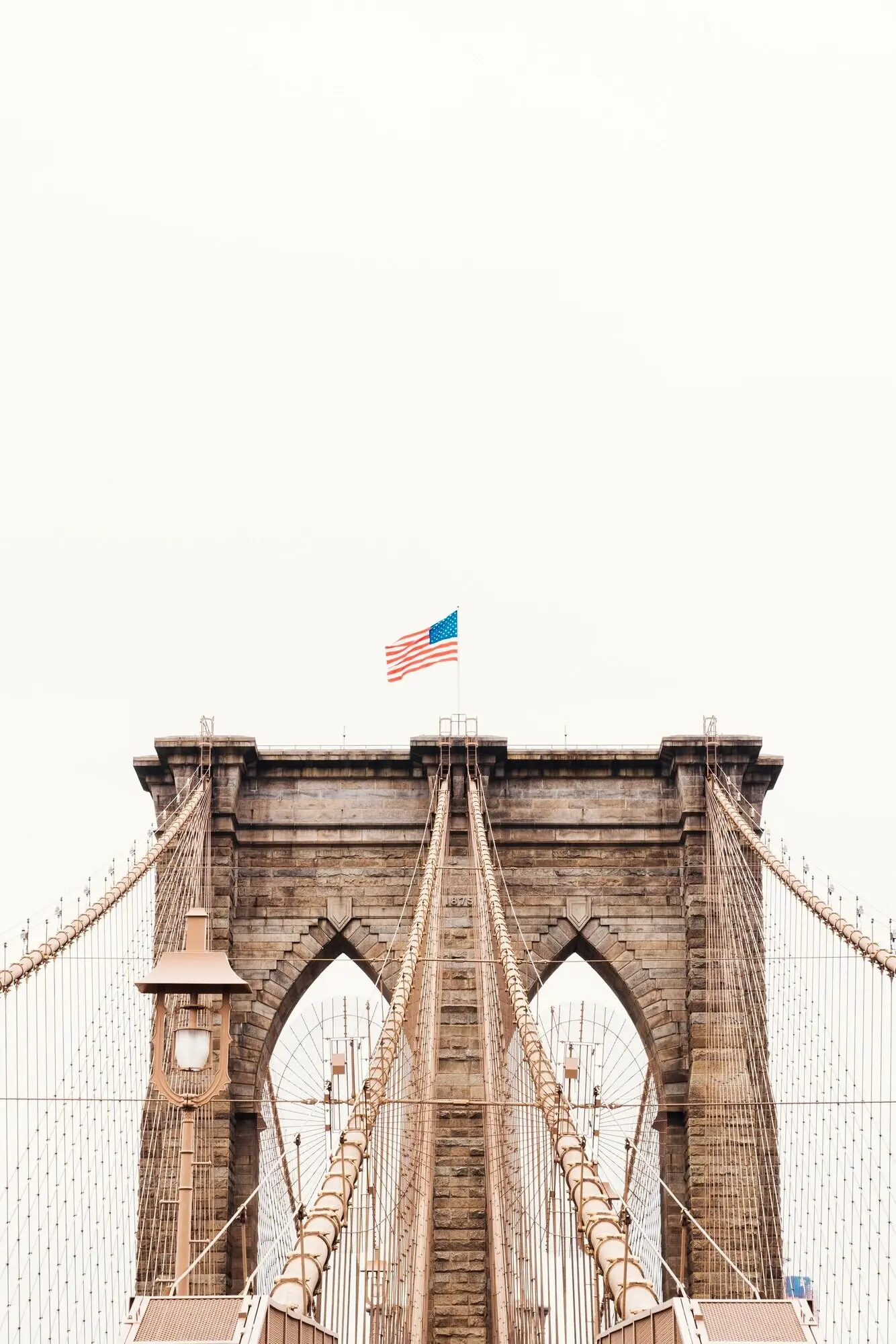 The Brooklyn Bridge with a U.S. flag